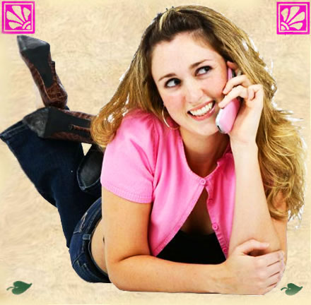 Smiling woman chatting on a pink telephone